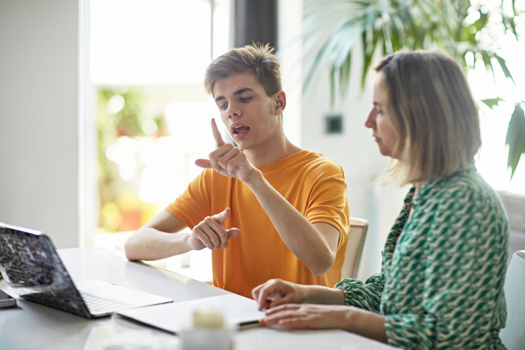 Deaf teenage boy signing while e-learning from home